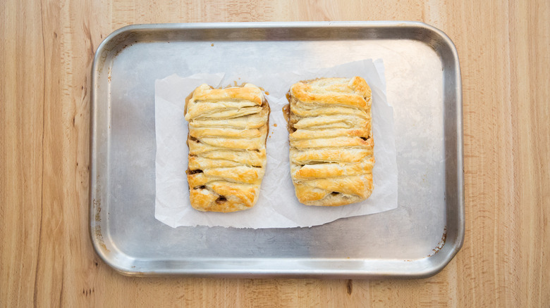 braided pastries on baking sheet