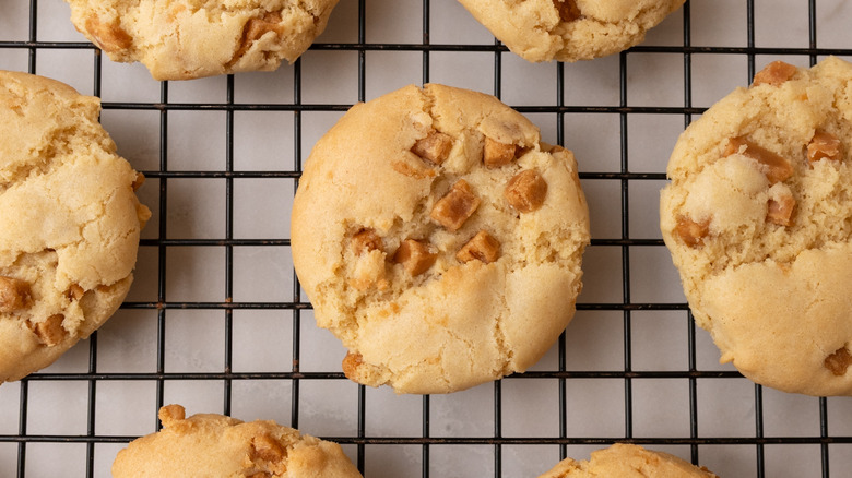 easy soft caramel cookies spaced out on a wire rack