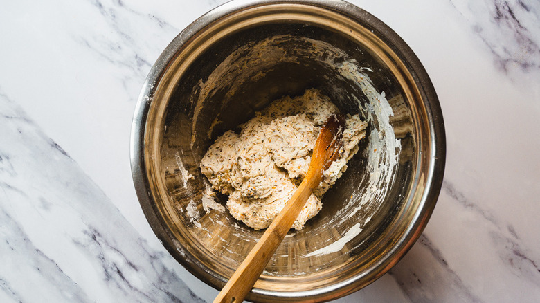 Dough in bowl with wooden spoon