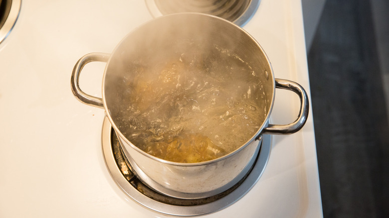 potatoes boiling in medium pot