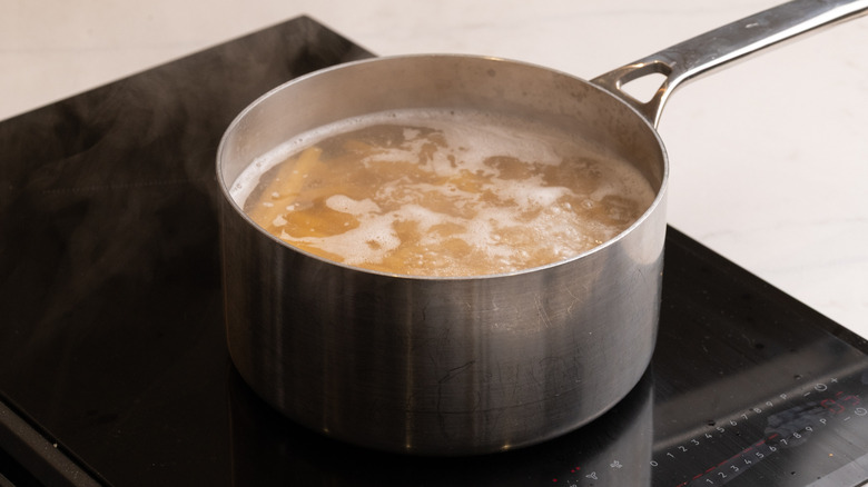 ziti pasta cooking in pan