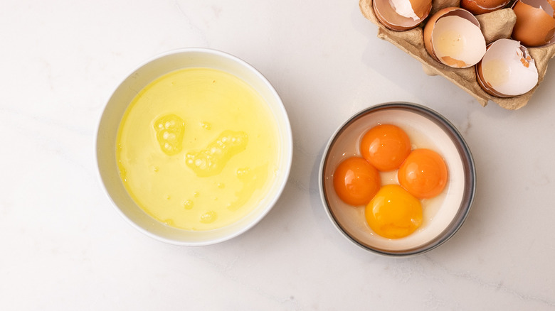 egg whites and yolks separated into two different bowls