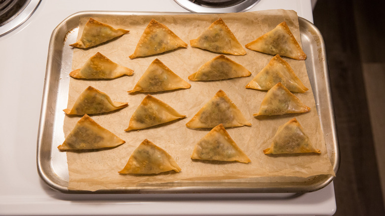 baked samosas on baking sheet