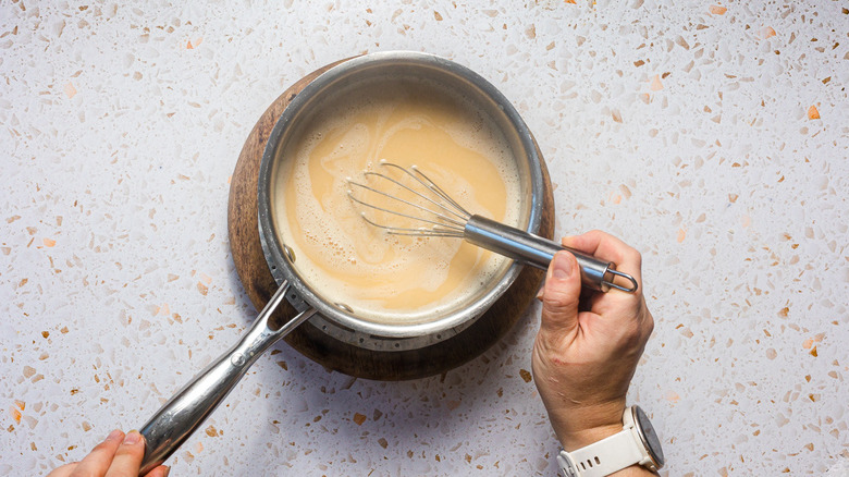 Whisking saucepan with caramel