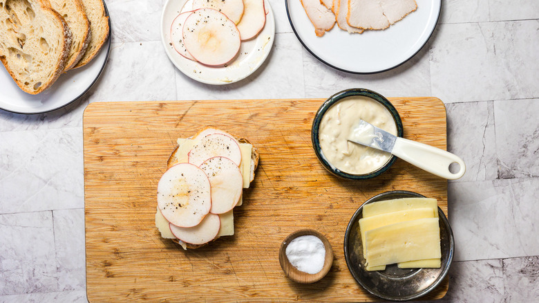 Assembling an apple turkey and cheddar sandwich