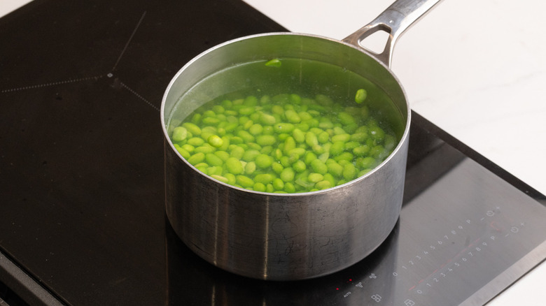 edamame beans simmering in pan