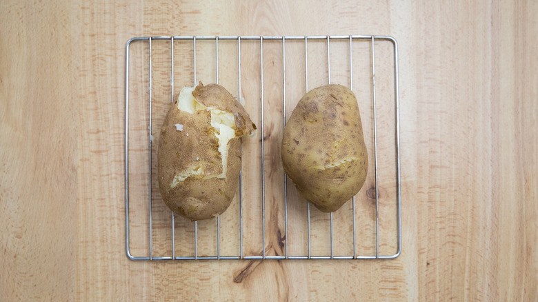two potatoes on cooling rack