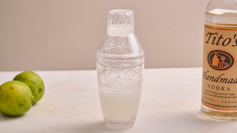 shaking cocktail inside cocktail shaker