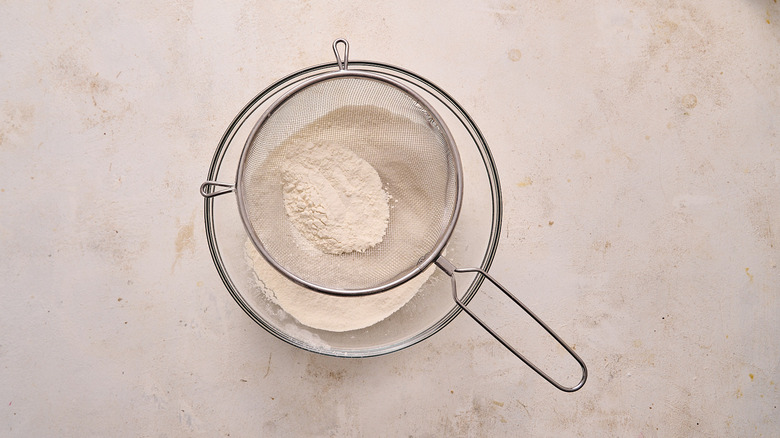 sifting dry ingredients in a bowl