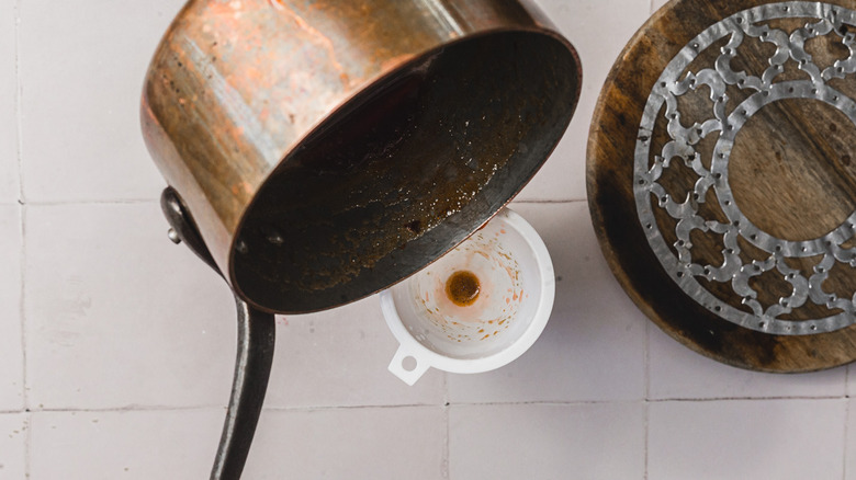 Pouring syrup through a funnel
