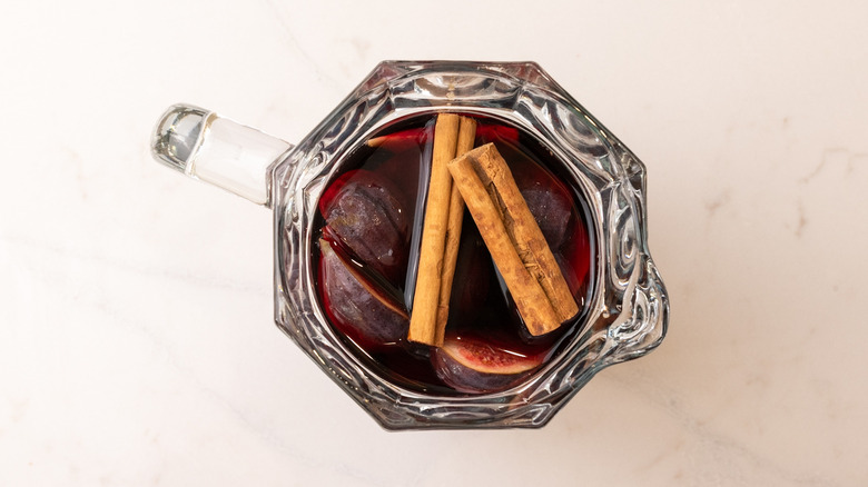 Top down view of sangria with cinnamon sticks in pitcher