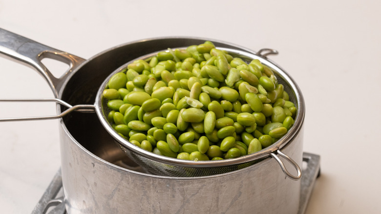 cooked edamame beans in sieve
