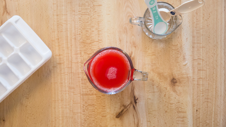 watermelon juice in measuring cup