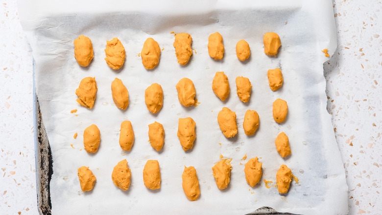 Raw sweet potato tater tots on cookie sheet