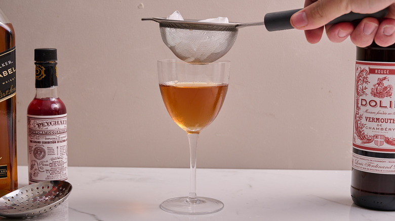 straining liquors into serving glass