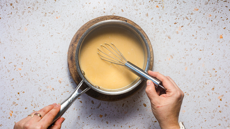 Whisking saucepan with caramel