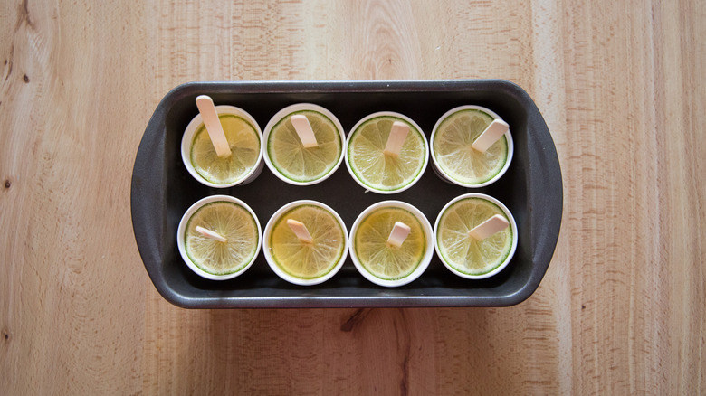 margarita popsicles with lime slices arranged in loaf pan