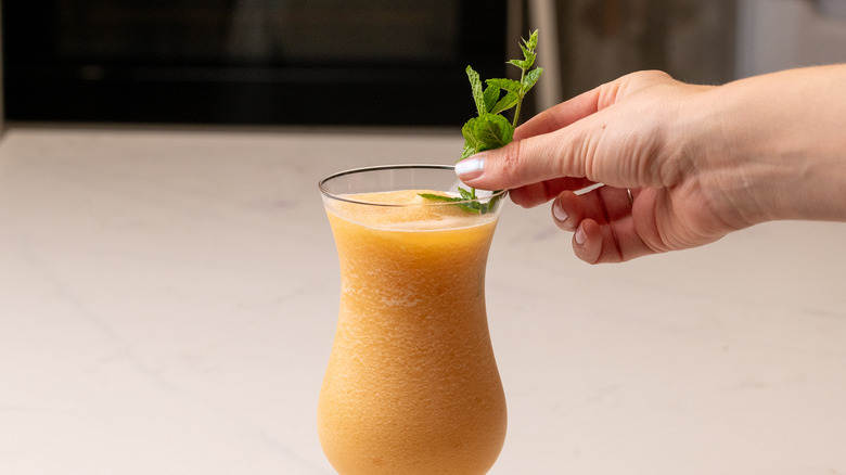 garnishing a frozen zombie cocktail