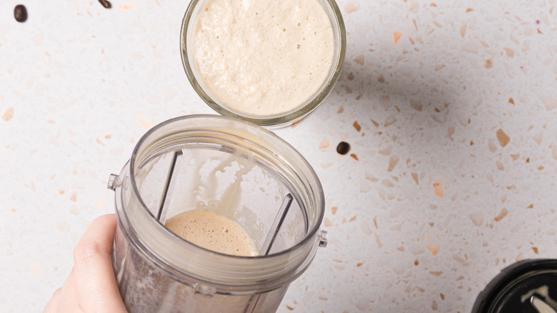 Pouring frappe into glass