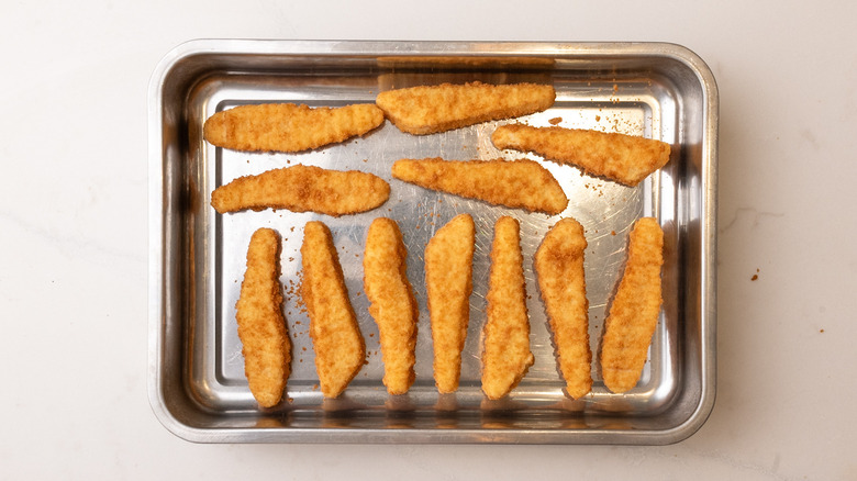 chicken tenders on baking sheet