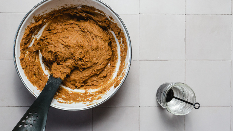 Pumpkin bread batter next to glass with water