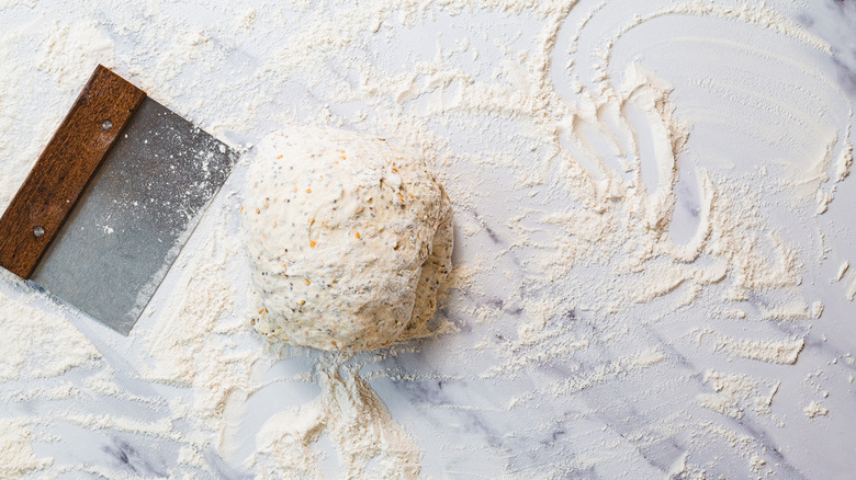 Dough on counter with dough scraper
