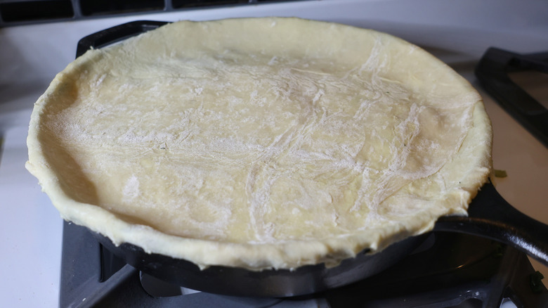 cast iron skillet topped with raw puff pastry