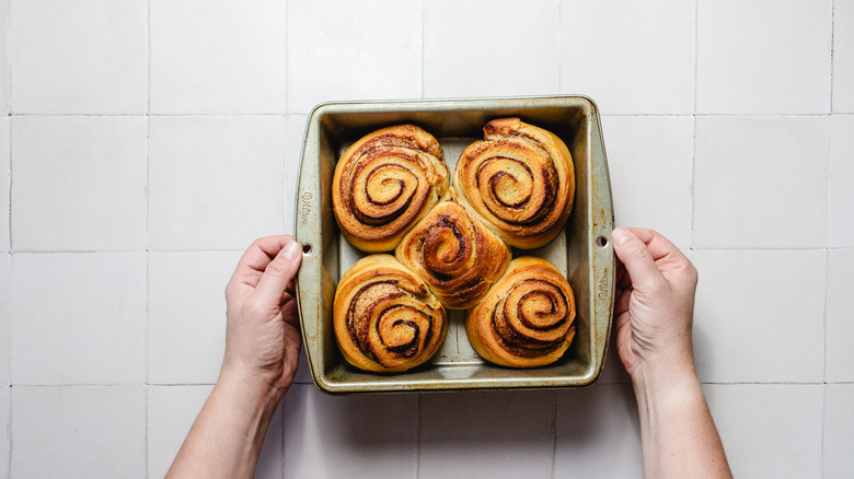 Baked, unfrosted cinnamon rolls in baking dish