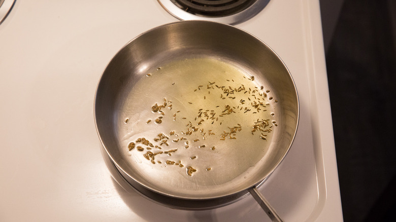 cumin seeds cooking in oil