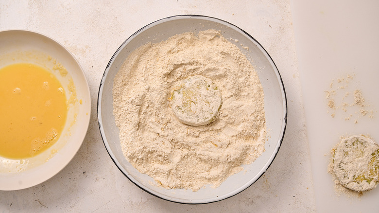 dredging tomatoes in flour