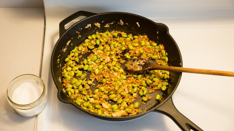 sauteed edamame in iron pan