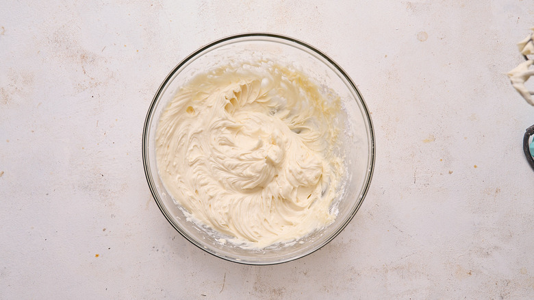 beating the frosting in a bowl