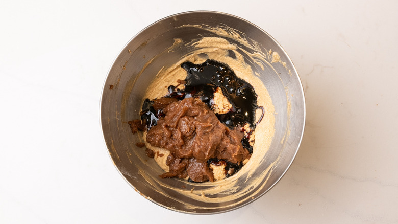 Cake batter in mixing bowl with black treacle and date puree