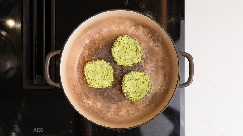 edamame fritters cooking in pan