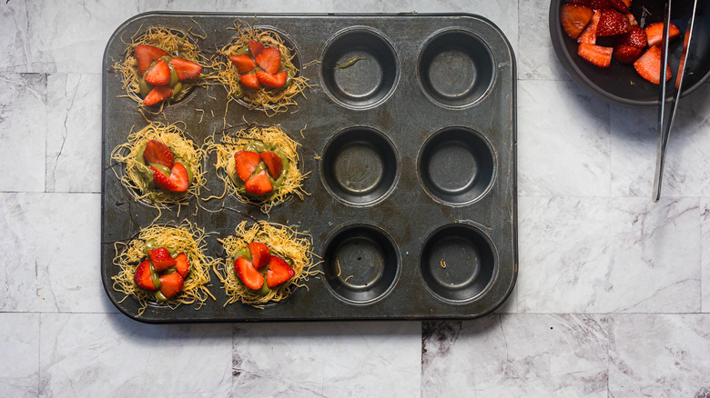 Muffin tin with kataifi noodle nests with strawberries
