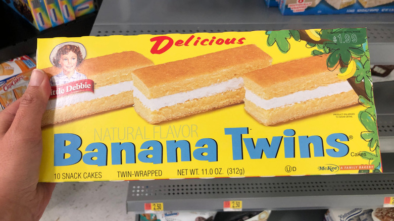 Hand holding a box of Little Debbie Banana Twins