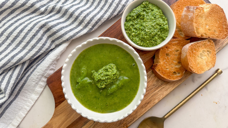 Bowl of spinach soup with crusty bread