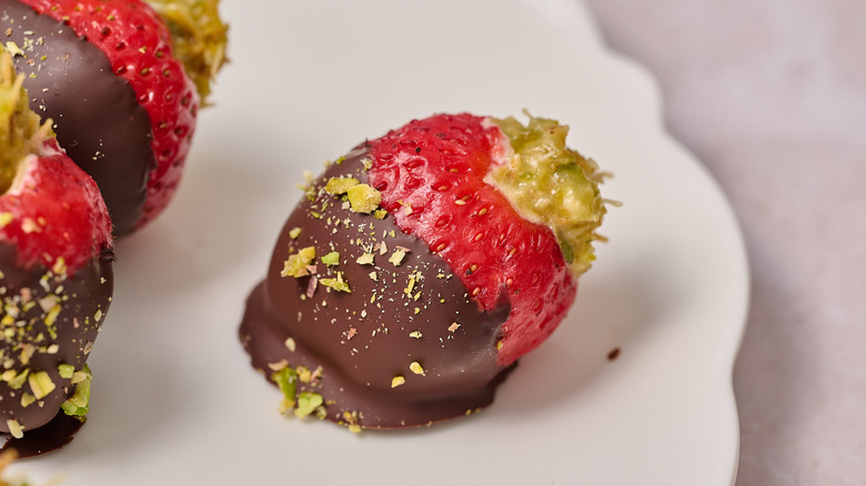 pistachio filled strawberries on a table