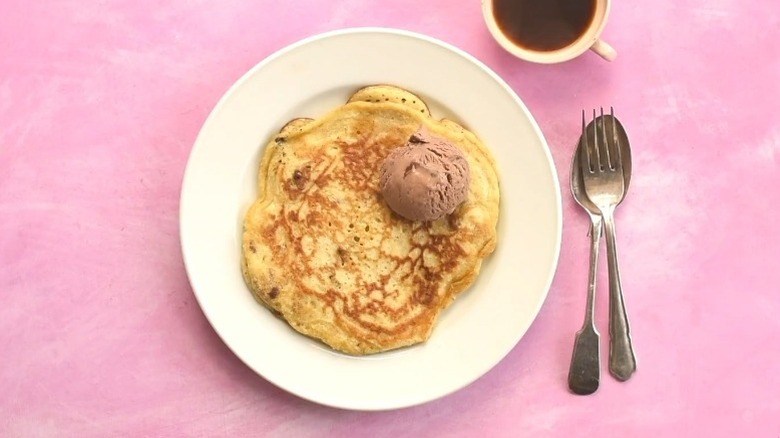 Cookie dough pancake on plate with scoop of chocolate ice cream